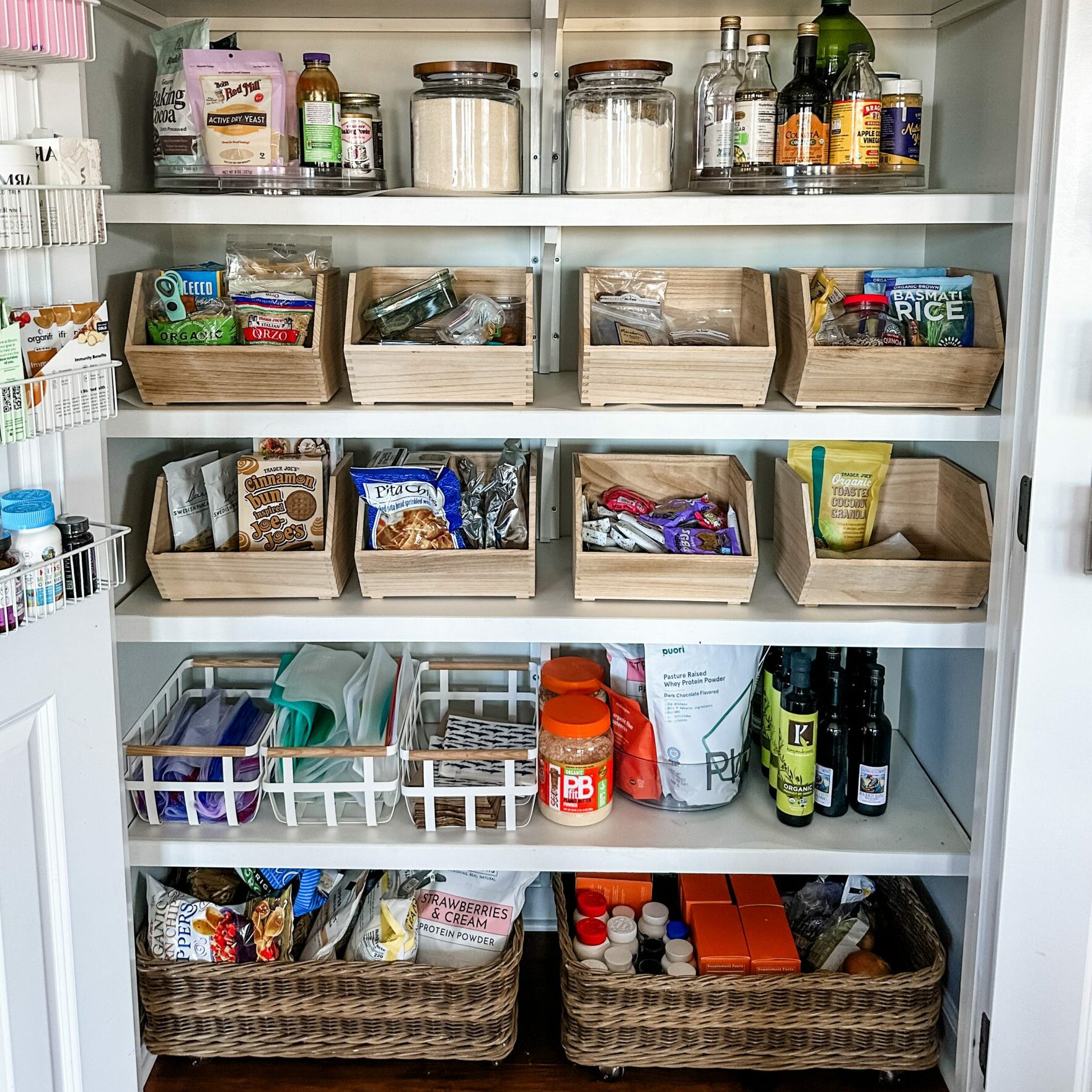 Pantry supplies grouped into wooden bins and baskets
